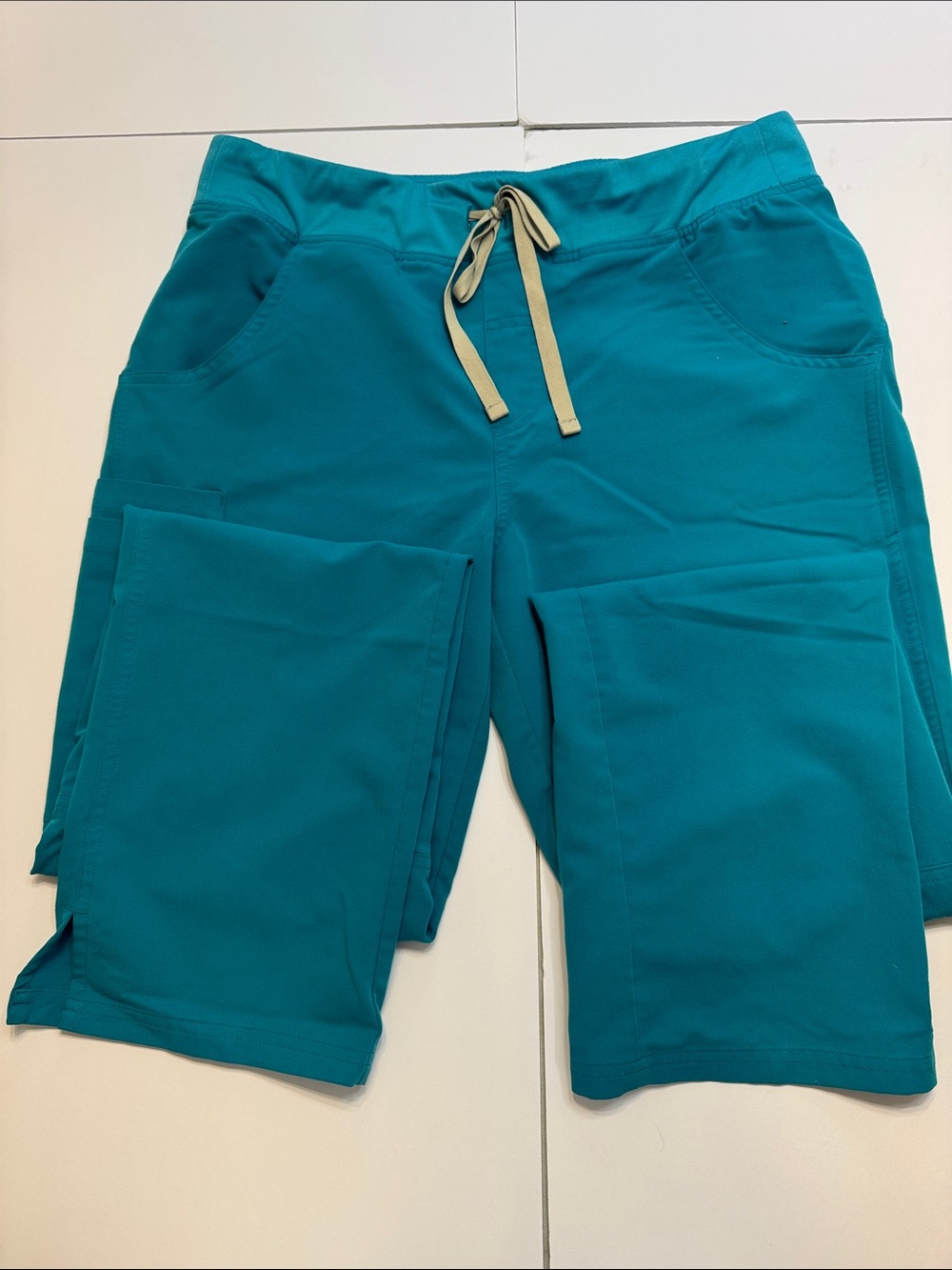 FIGS Technical Collection pantsin Teal with Beige Print